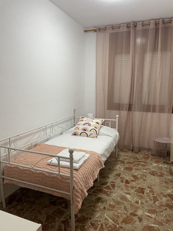 Cama de forja y cortinas de lino