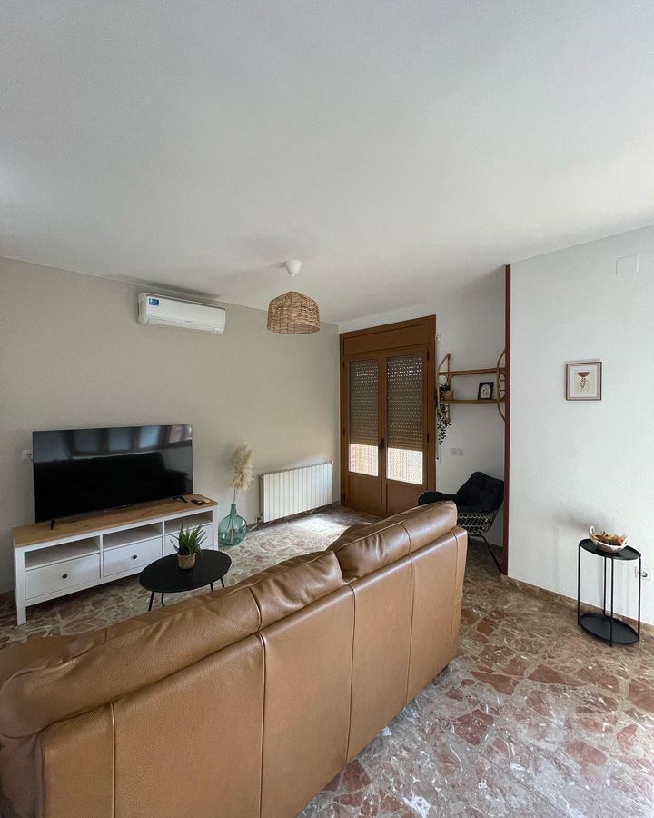 Lounge with leather sofa and TV