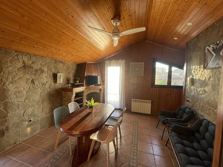 Lounge with wooden ceiling and stone wall